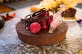 Detail of luxury oval chocolate lava cake with raspberry and strawberry decoration on top