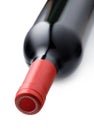 Detail of a lying bottle of red wine on a white background Royalty Free Stock Photo