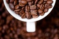 Detail, macro view of coffee mug with aromatic black coffee bean