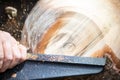 Detail macro of wood turning with flying sawdust shavings