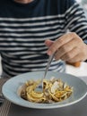 Detail male hand eating pasta spaghetti with clams and mullet, Mediterranean food Royalty Free Stock Photo