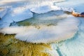 Detail on Mammoth Hot Springs with steamy terraces during winter snowy season in Yellowstone National Park, Wyoming