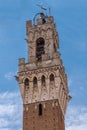 Detail of Mangia Tower and its tabernacle, the civic tower of the town hall of Siena in Piazza del campo. Tuscany, Italy Royalty Free Stock Photo