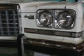 Detail of massive chrome grille and twin round headlights of american full-size car Pontiac Grand Ville from year 1973