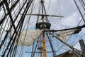 Detail of mast of ship. Detailed rigging with sails. Vintage sailing ship block and tackle. Royalty Free Stock Photo