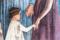 Detail of medieval italian illustration showing little boy holding his motherÃÂ´s hand