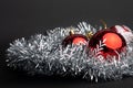 Detail of Merry Christmas and Happy Holidays red balls on gray ribbon Royalty Free Stock Photo