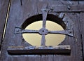 Detail, in metal that forms the shape of a cross, of an ancient door of a Barga palace in the province of Lucca in Tuscany.