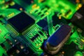 Detail of a microprocessor, resistors and capacitors soldered to a green glowing PCB Royalty Free Stock Photo