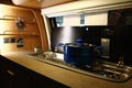 Detail of modern mobile kitchen with two gas burners and kitchen sink installed in campervan.