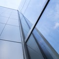 Detail of modern office building with glass and steel reflecting blue sky Royalty Free Stock Photo