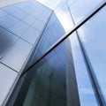 Detail of modern office building with glass and steel reflecting blue sky Royalty Free Stock Photo