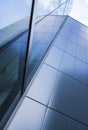Detail of modern office building with glass and steel reflecting blue sky Royalty Free Stock Photo