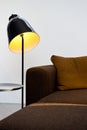 Detail of modern design lamp next to the brown sofa Royalty Free Stock Photo