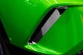Detail of a modern exhaust on a green car