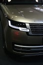 Detail of modern front mask of new british large luxury SUV car Range Rover L460 with day lighting LED light turned on.