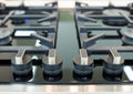 Detail of a modern gas hob with round handles Royalty Free Stock Photo