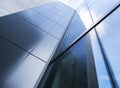 Detail of modern office building with glass and steel reflecting blue sky Royalty Free Stock Photo