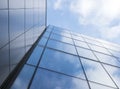 Detail of modern office building with glass and steel reflecting blue sky Royalty Free Stock Photo