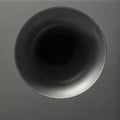 Detail modern subwoofer, closeup, audio speaker. Circle membrane sound speaker on black background