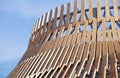 Detail of a modern wooden architecture in glued laminated timber on blue sky