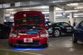 modified Mugen engine of the red Honda CR-X Del Sol parked in the parking lot