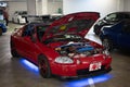 modified Mugen engine of the red Honda CR-X Del Sol parked in the parking lot