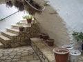 Detail from the Monastery of Paleokastritsa, corner with Arcade and stairs with flower pots, Corfu, Greece