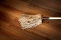 Detail of a mop on wooden surface Royalty Free Stock Photo