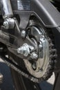 Detail of a motorcycle wheel, swingarm, sprocket and rear drive chain