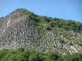 Detail of a mountain of basalt with columnar jointing in the Auvergne Volcanos in France. Royalty Free Stock Photo