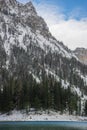 Detail of mountain face with rocks, snow and trees near Green lake Grunner see in sunny winter day. Famous tourist destination