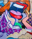 Detail of a mural graffiti depicting a woman`s mouth with red lipstick