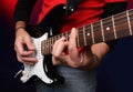 Detail of a musician playing a black electric guit Royalty Free Stock Photo