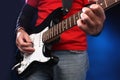 Detail of a musician playing a black electric guit Royalty Free Stock Photo