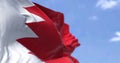 Detail of the national flag of Bahrain waving in the wind on a clear day