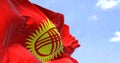Detail of the national flag of Kyrgyzstan waving in the wind on a clear day