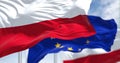 Detail of the national flag of Poland waving in the wind with blurred european union flag in the background