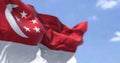 Detail of the national flag of Singapore waving in the wind on a clear day