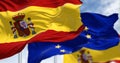 Detail of the national flag of Spain waving in the wind with blurred european union flag in the background Royalty Free Stock Photo