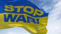 Detail of the national flag of Ukraine with the STOP WAR text waving in the wind
