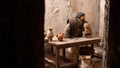 detail of Nativity scene: craftsman works ceramic amphorae