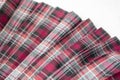 Detail of new fashion plaid pleated skirt: red, maroon, gray tartan school uniform fabric cotton/woolen material Royalty Free Stock Photo