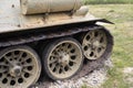 Detail of old aged military vehicle with continous track and wheels