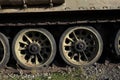 Detail of old aged military vehicle with continous track and wheels