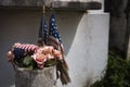 Detail of old American flags and flowers placed in a tomb in a New Orleans cemetery, in Louisiana