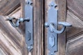 Detail of an old ancient wooden door with a beautiful iron handle. Royalty Free Stock Photo