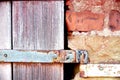 Close up of an old stable door with rusty hinge in a brick wall Royalty Free Stock Photo