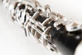 Detail of a old black clarinet on white background Royalty Free Stock Photo