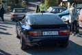 Detail of an old black Porsche 944 German sports car.